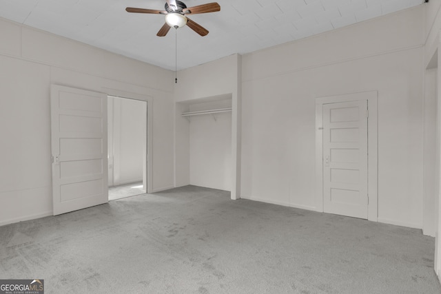 unfurnished bedroom featuring light carpet, a closet, and ceiling fan