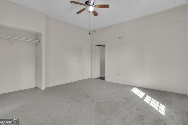 unfurnished bedroom featuring ceiling fan and carpet