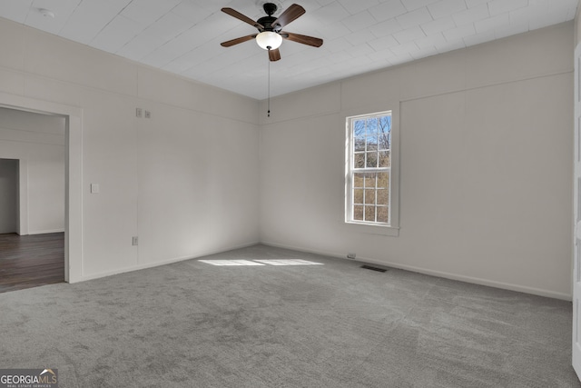 spare room featuring carpet flooring and ceiling fan