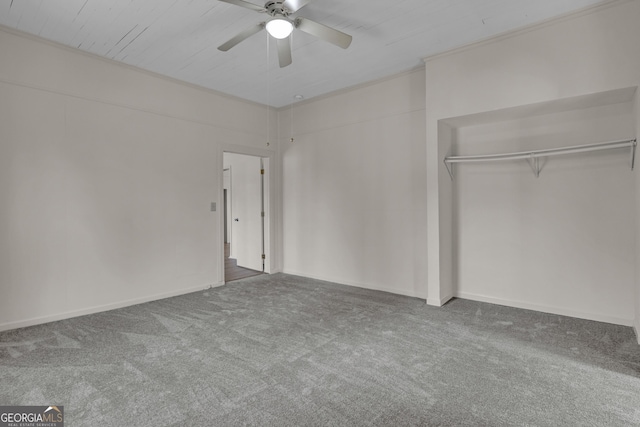 unfurnished bedroom with ornamental molding, carpet flooring, ceiling fan, and a closet