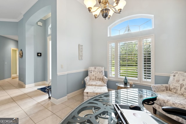 sitting room with an inviting chandelier, ornamental molding, a high ceiling, and light tile patterned flooring