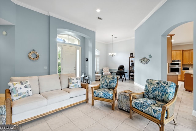 tiled living room with crown molding and a chandelier