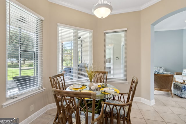 dining area featuring ornamental molding and light tile patterned floors