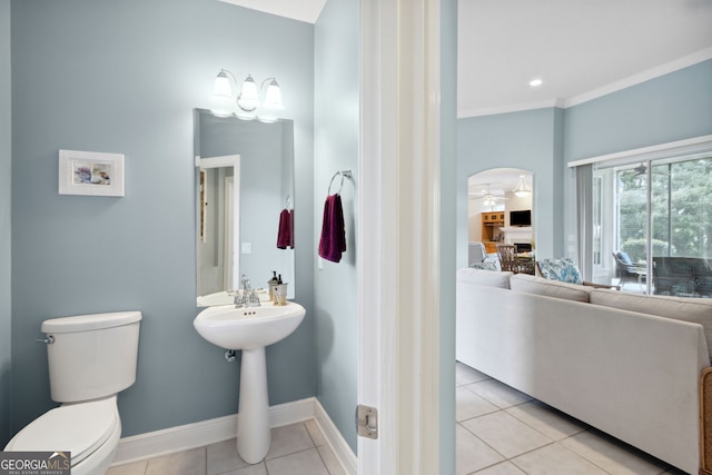 bathroom featuring ceiling fan, ornamental molding, tile patterned floors, and toilet