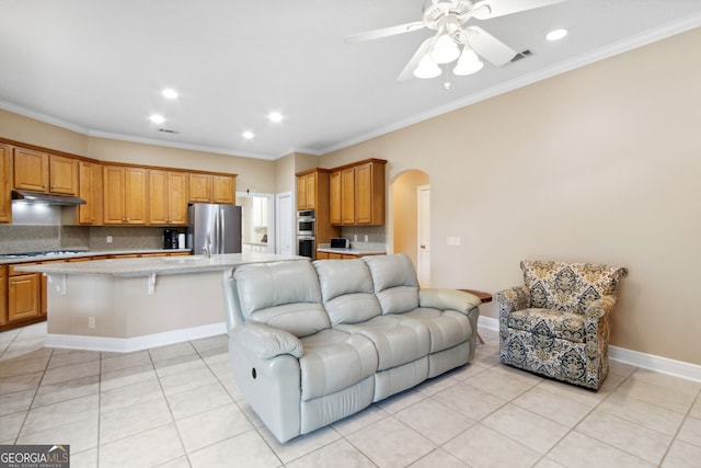 living room featuring ornamental molding, light tile patterned floors, and ceiling fan