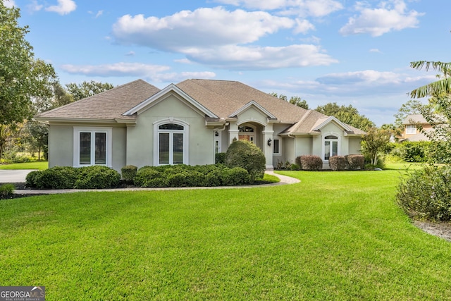 single story home featuring a front yard