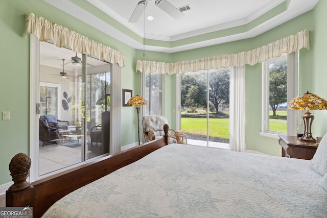 bedroom with crown molding, a tray ceiling, access to exterior, and wood-type flooring