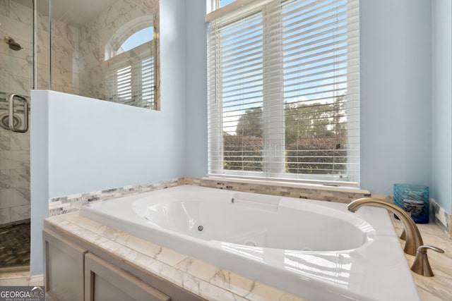 bathroom featuring independent shower and bath