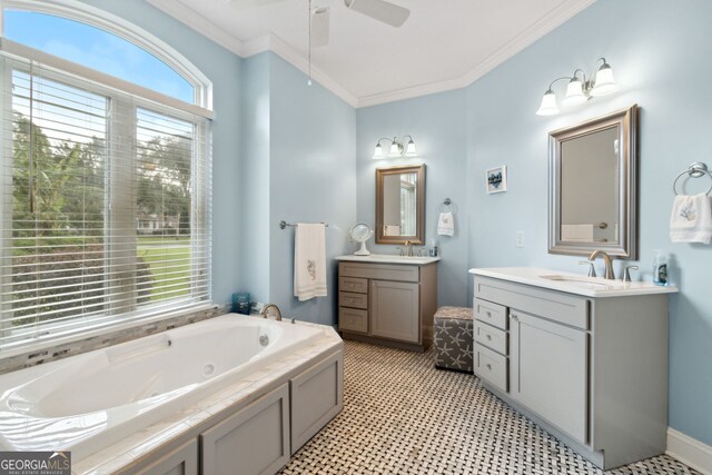 bathroom featuring ceiling fan, ornamental molding, vanity, and a tub