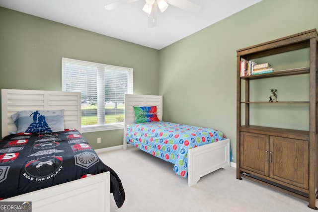 bedroom featuring light colored carpet and ceiling fan