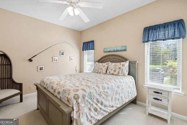 bedroom featuring light colored carpet and ceiling fan