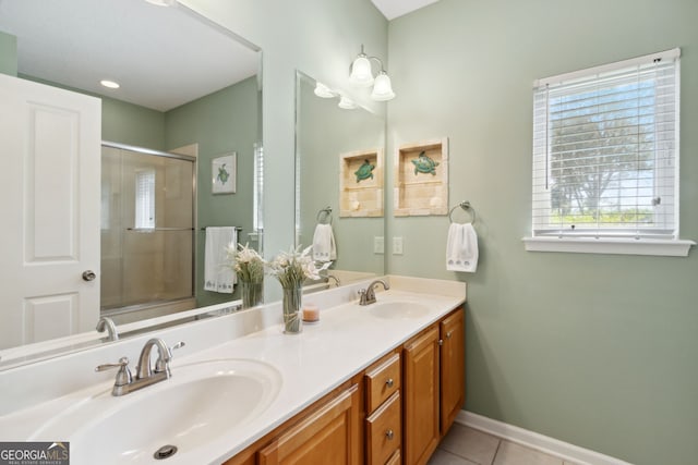 bathroom featuring tile patterned flooring, vanity, and a shower with shower door