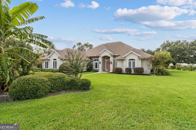 single story home featuring a front yard