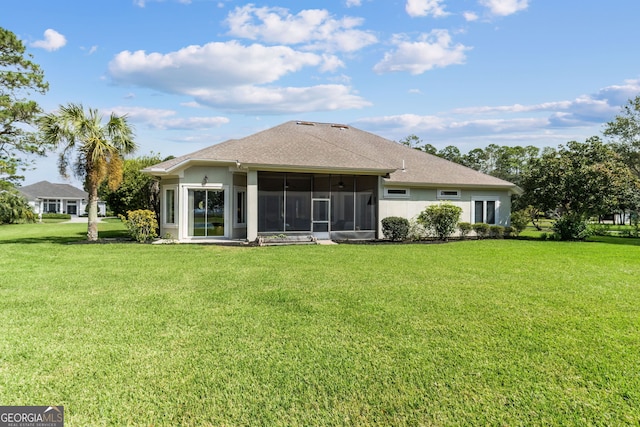 back of house featuring a yard and a sunroom