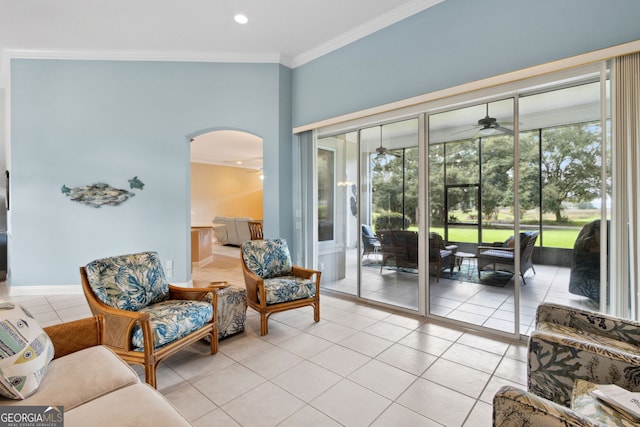 sitting room featuring light tile patterned flooring, ceiling fan, and crown molding