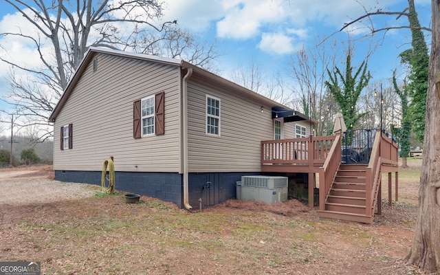 view of home's exterior featuring a wooden deck