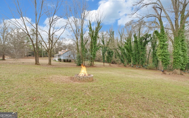 view of yard with an outdoor fire pit