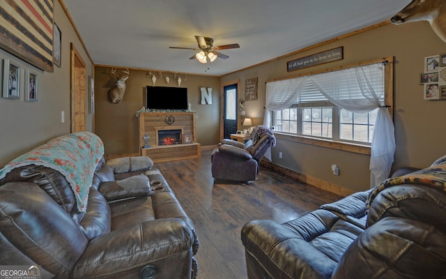 living room featuring crown molding, ceiling fan, and dark hardwood / wood-style flooring