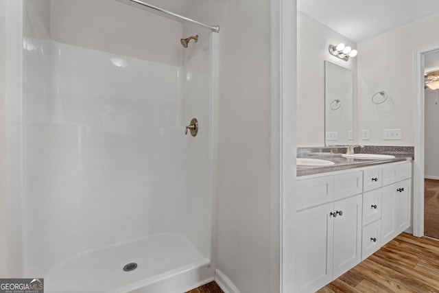 bathroom featuring vanity, hardwood / wood-style floors, and a shower