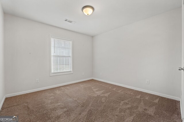 spare room featuring carpet