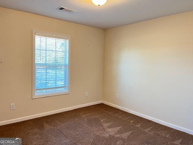 empty room with dark carpet