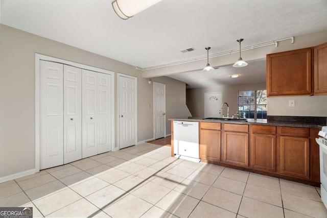 kitchen featuring sink, pendant lighting, white appliances, and light tile patterned floors