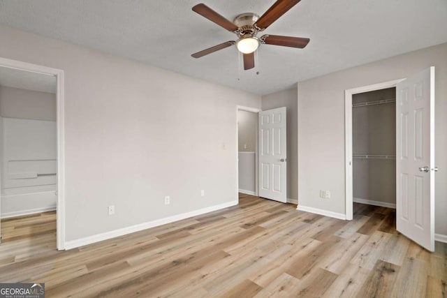 unfurnished bedroom with ceiling fan, light hardwood / wood-style floors, and a closet