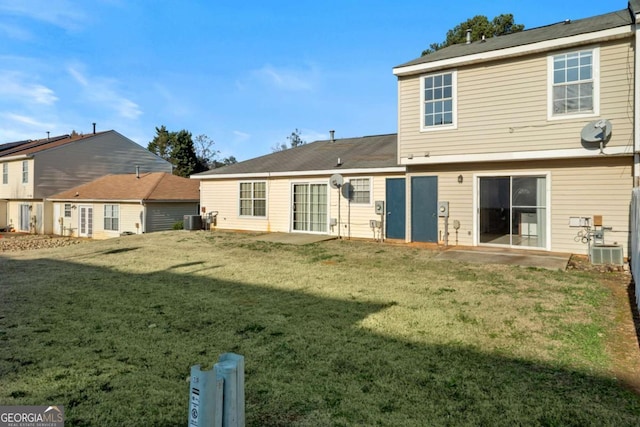 back of house featuring a yard, central air condition unit, and a patio area