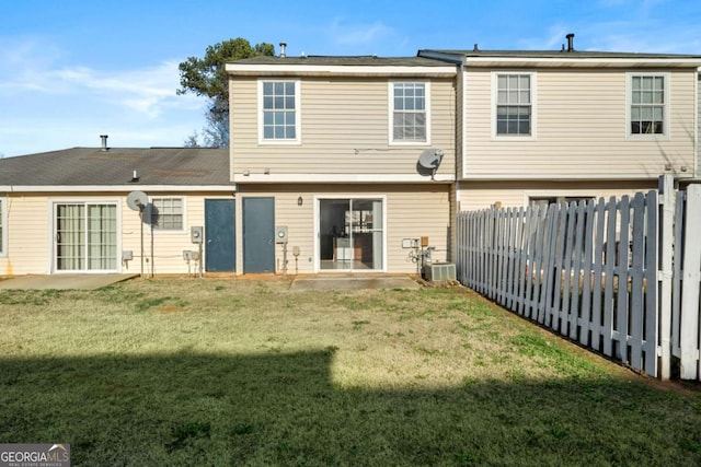 rear view of property with a lawn and a patio area