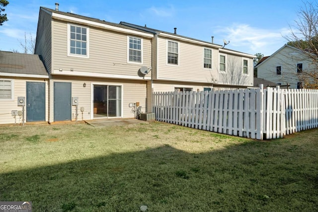 back of property featuring cooling unit and a lawn