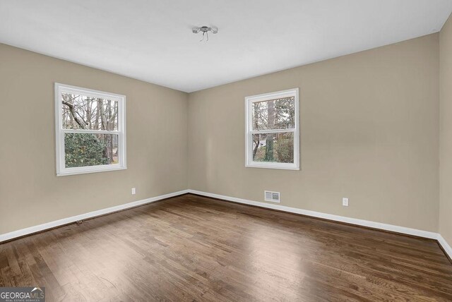 spare room featuring wood-type flooring