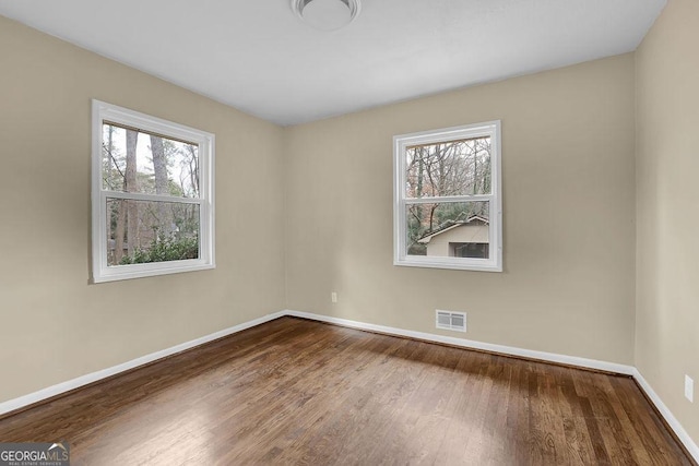 empty room with hardwood / wood-style floors