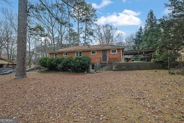 rear view of house featuring a carport