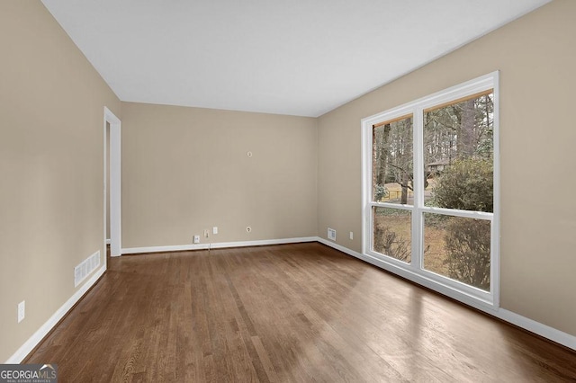 empty room with hardwood / wood-style floors