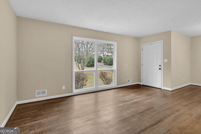 empty room featuring hardwood / wood-style flooring