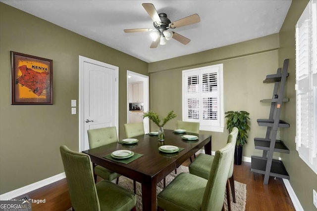 dining space with dark hardwood / wood-style flooring and ceiling fan