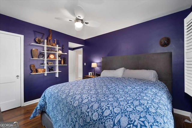 bedroom with ceiling fan and dark hardwood / wood-style flooring