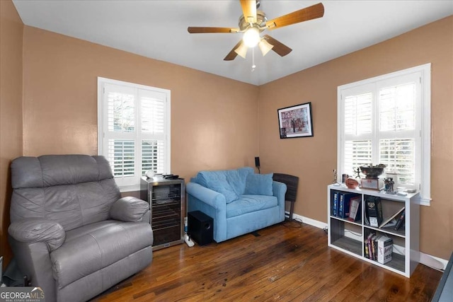 sitting room with ceiling fan, wine cooler, and dark hardwood / wood-style flooring