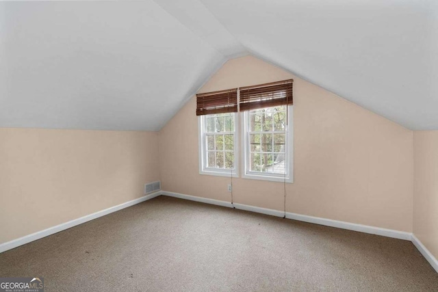 bonus room featuring lofted ceiling and carpet