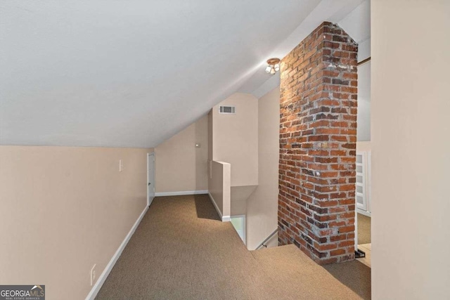 additional living space featuring lofted ceiling and carpet flooring