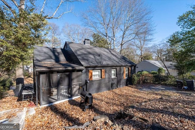 rear view of property with a sunroom