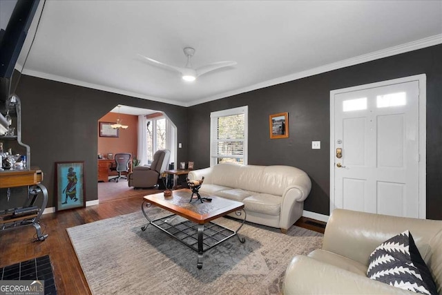 living room featuring crown molding, ceiling fan, and dark hardwood / wood-style floors