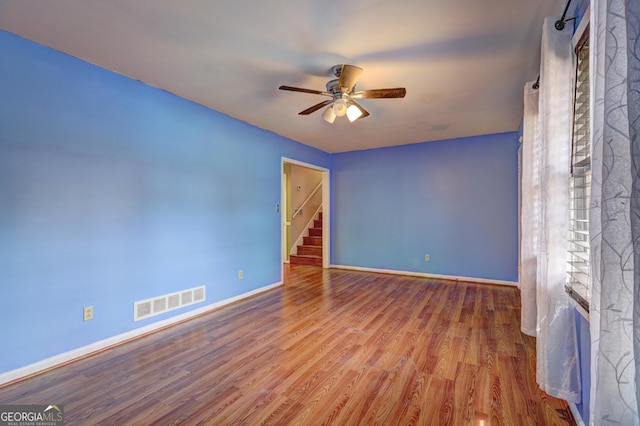 unfurnished room with ceiling fan and hardwood / wood-style floors