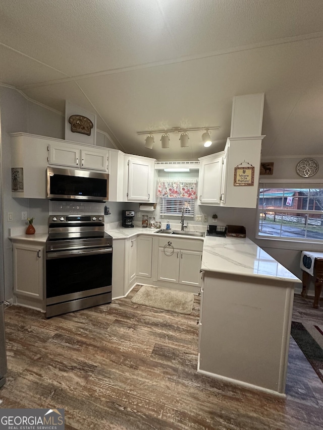 kitchen with white cabinetry, appliances with stainless steel finishes, dark wood-type flooring, and sink