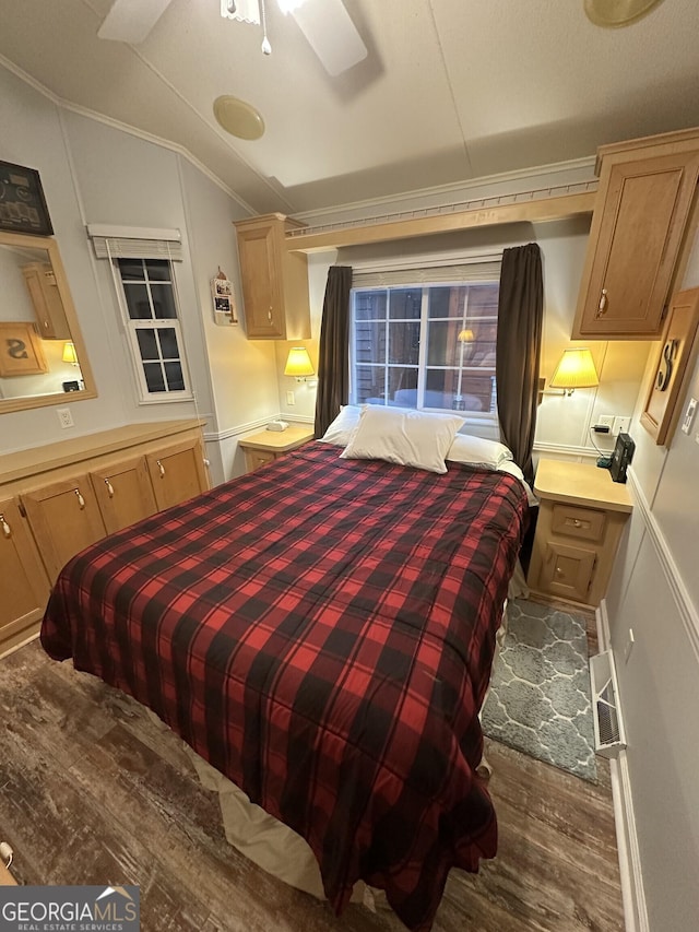 bedroom featuring crown molding, ceiling fan, lofted ceiling, and wood-type flooring