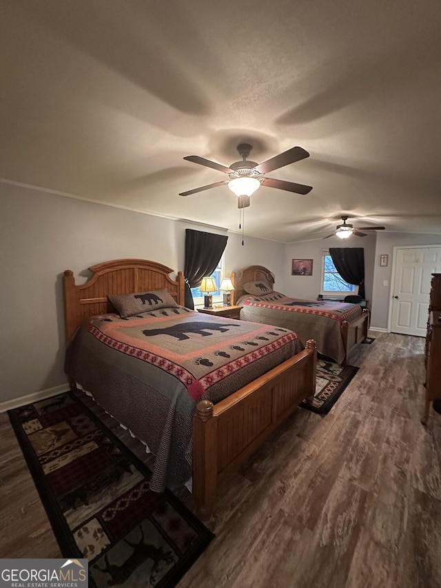 bedroom with ceiling fan and dark hardwood / wood-style floors