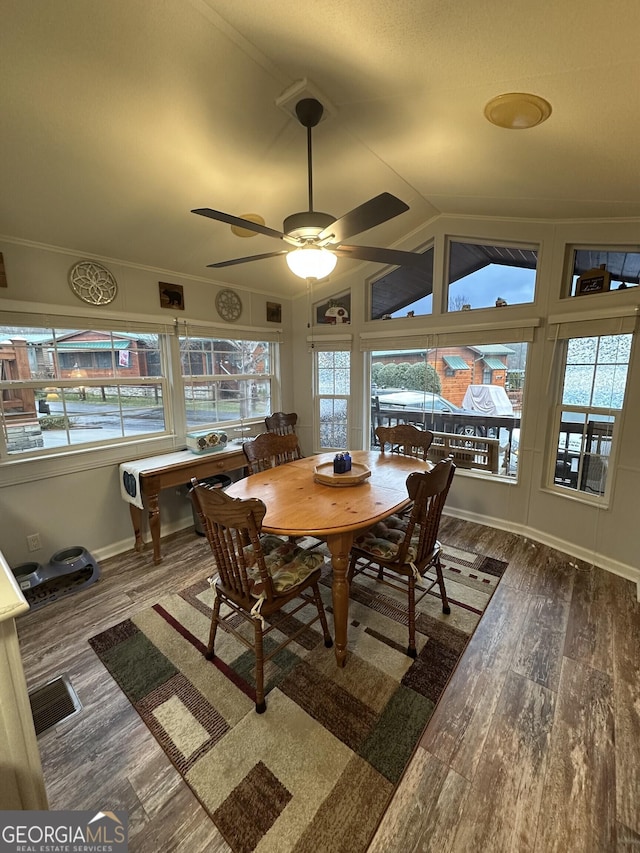 dining space featuring crown molding, vaulted ceiling, dark hardwood / wood-style floors, and ceiling fan