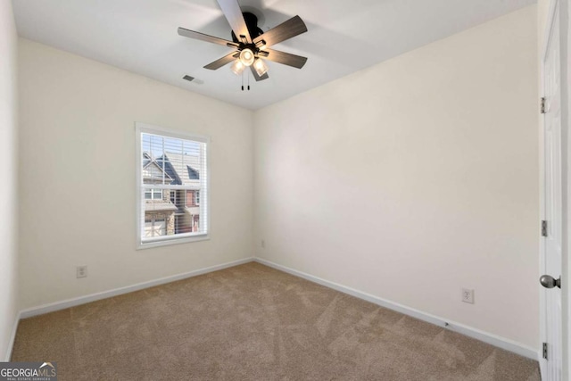 unfurnished room with ceiling fan and light colored carpet