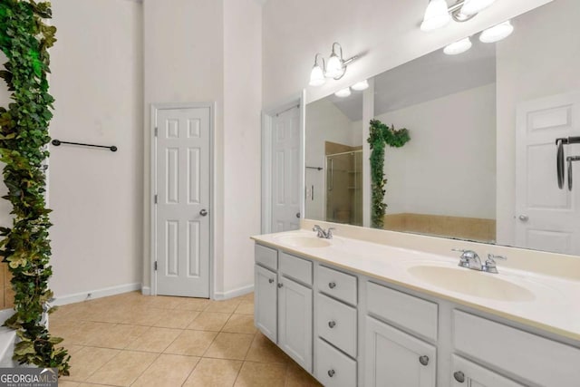 bathroom with vanity, a shower with door, and tile patterned floors