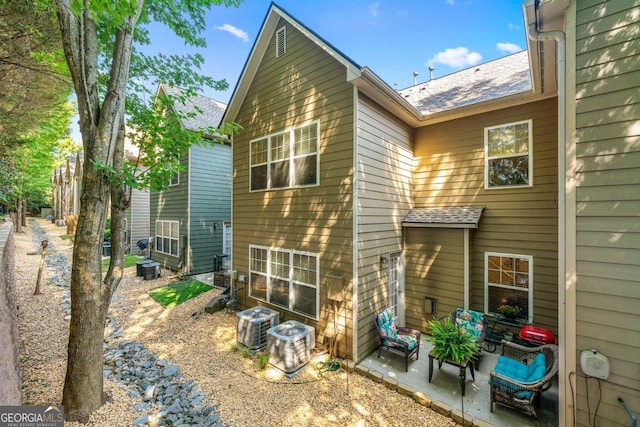 back of house featuring cooling unit and a patio area